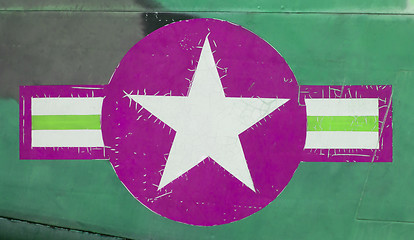 Image showing Tail of Vietnam war Airplane, green and pink