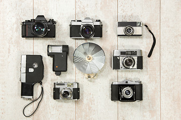 Image showing Vintage Cameras With Flash On Floorboard