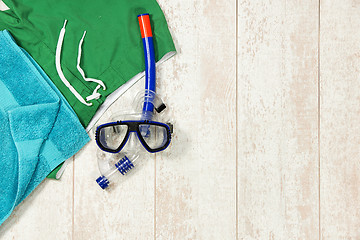 Image showing Swimming Trunks, Towel And Snorkeling Mask On Floorboard