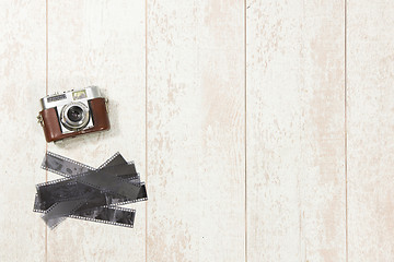 Image showing Vintage Camera And Film Strips On Floorboard