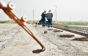 Image showing Workers do fittings binding