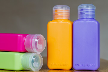 Image showing Small colored plastic bottles for traveling