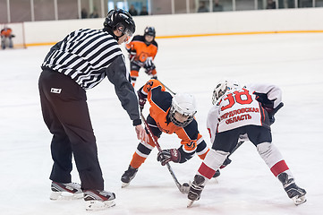 Image showing Puck playing between players of ice-hockey teams