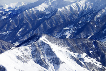 Image showing Top view on snowy mountains with forest