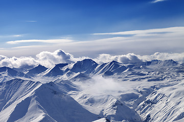 Image showing Snow plateau and sunlight sky with clouds in evening