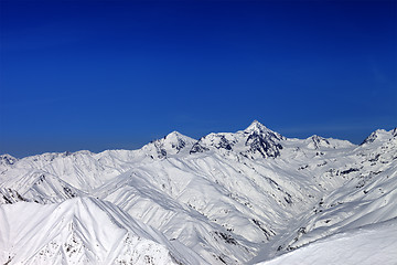 Image showing Snowy mountain peaks in sun day