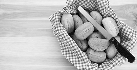 Image showing Basket of petit pain and a bread knife 