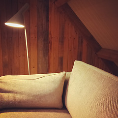 Image showing Sofa and lamp in a room with wooden walls
