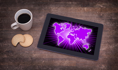 Image showing World map on a tablet