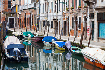 Image showing Gondolas moored along water channel