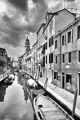 Image showing Gondolas moored in water canal bw