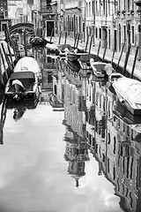 Image showing Empty gondolas moored in water canal bw