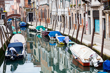 Image showing Empty gondolas moored along water canal