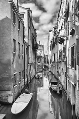 Image showing Gondolas parked in water canal bw