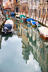 Image showing Empty gondolas moored in water canal