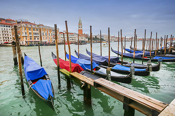 Image showing Moored gondolas at dock in Venice