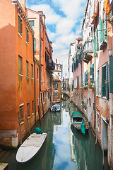 Image showing Gondolas parked next to buildings in water canal