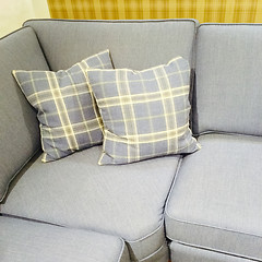 Image showing Checked cushions on gray sofa