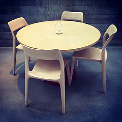 Image showing Wooden table and chairs in a dark room