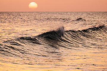 Image showing Breaking wave at sunset