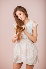 Image showing Smiling Girl combs her hair