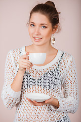 Image showing Woman with cup and saucer