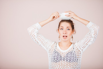 Image showing Suprised Woman with cup and saucer