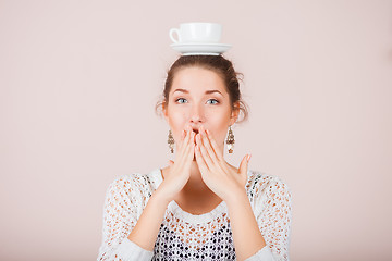 Image showing Suprised Woman with cup and saucer