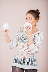 Image showing Suprised Woman with cup and saucer