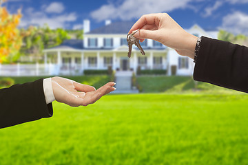 Image showing Agent Handing Over House Keys in Front of New Home