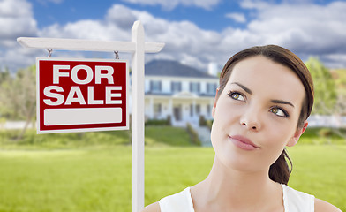 Image showing Thinking Woman In Front of House and For Sale Sign