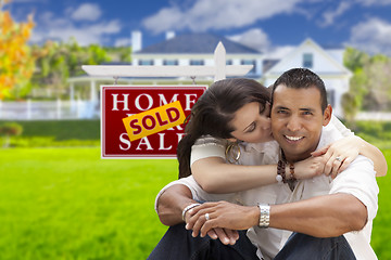 Image showing Hispanic Couple, New Home and Sold Real Estate Sign