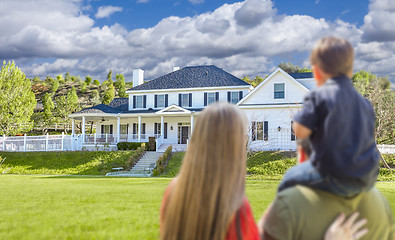 Image showing Mixed Race Young Family Looking At Beautiful Home