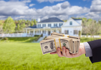 Image showing Handing Over Cash For House in Front of Home