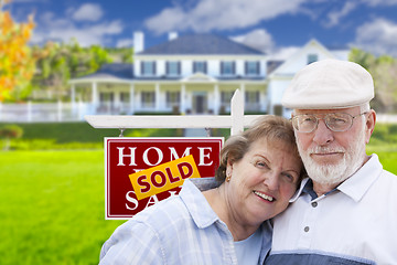 Image showing Senior Couple in Front of Sold Real Estate Sign and House