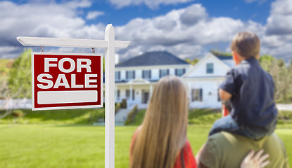 Image showing Family Facing For Sale Real Estate Sign and House