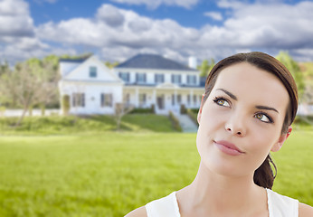 Image showing Thoughtful Mixed Race Woman In Front of House