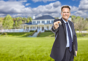 Image showing Real Estate Agent with House Keys in Front of Home