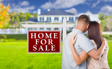 Image showing For Sale Real Estate Sign, Military Couple Looking at House