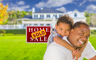 Image showing Father and Son In Front of Sold Sign and House