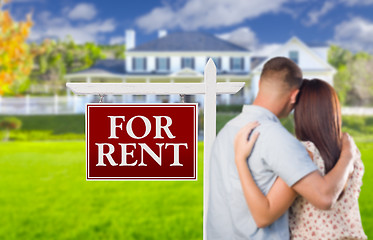 Image showing For Rent Real Estate Sign, Military Couple Looking at House