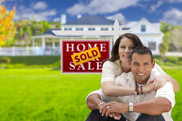 Image showing Hispanic Couple, New Home and Sold Real Estate Sign