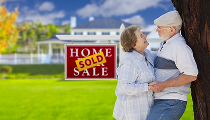 Image showing Sold Real Estate Sign with Senior Couple in Front of House