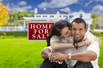 Image showing Hispanic Couple, New Home and For Sale Real Estate Sign