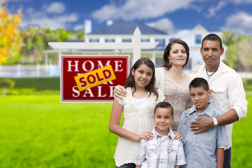 Image showing Hispanic Family in Front of Sold Real Estate Sign, House