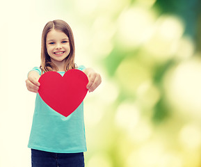 Image showing smiling little girl giving red heart