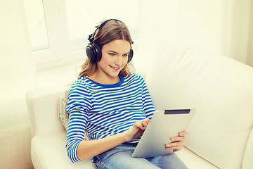 Image showing girl with tablet pc and headphones at home