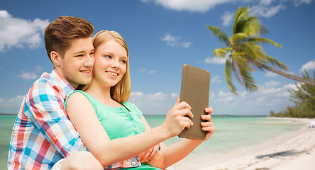 Image showing couple with tablet pc taking selfie over beach