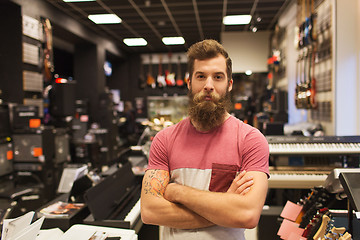 Image showing assistant or customer with beard at music store