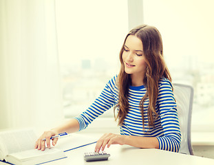 Image showing student girl with book, calculator and notebook